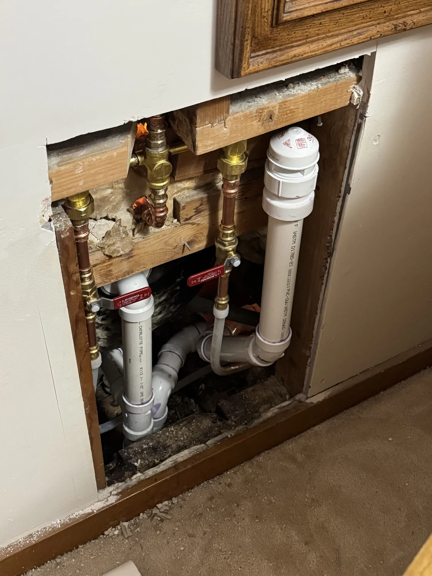 Wall opened to expose copper water lines and PVC drain lines during a Pittsburgh area remodel