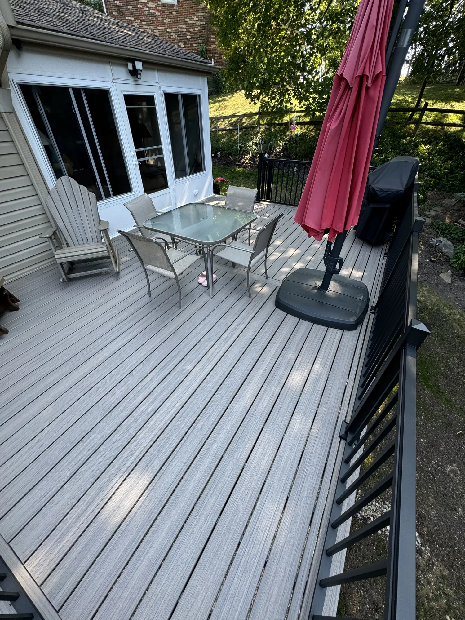 Composite deck with black railing and patio furniture at an Allison Park home