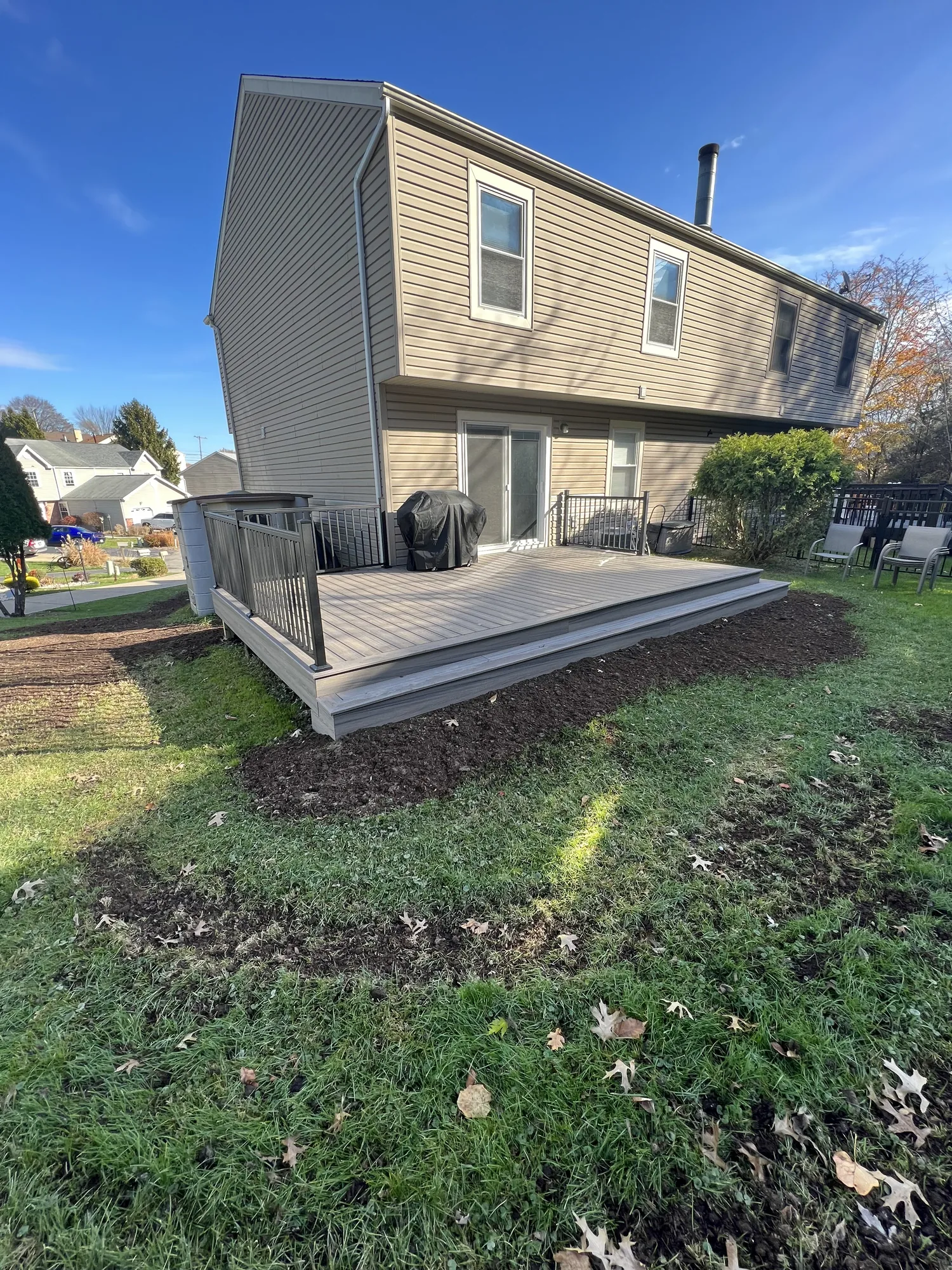 Freshly graded and backfilled soil along a home foundation in the North Hills of Pittsburgh