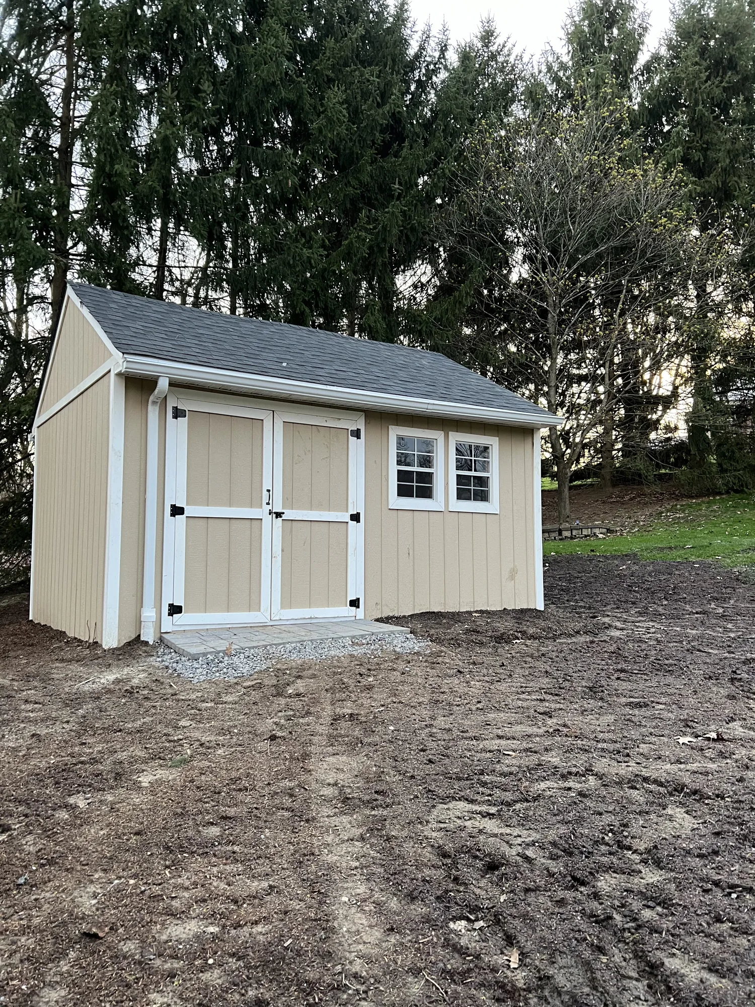 Storage shed set on a graded gravel pad after site prep in the North Hills of Pittsburgh