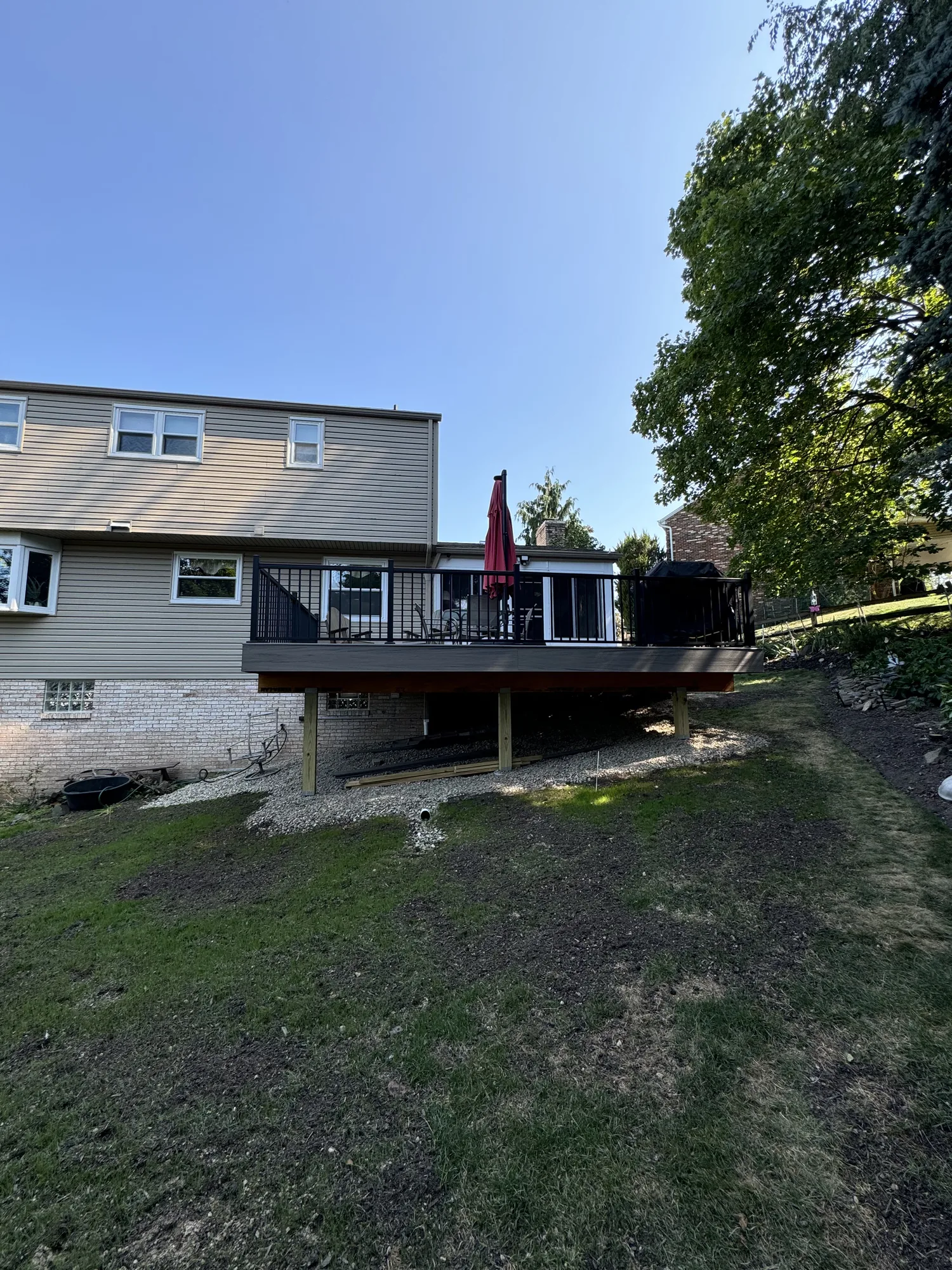 Raised deck under construction with regraded slope behind a home in the North Hills of Pittsburgh