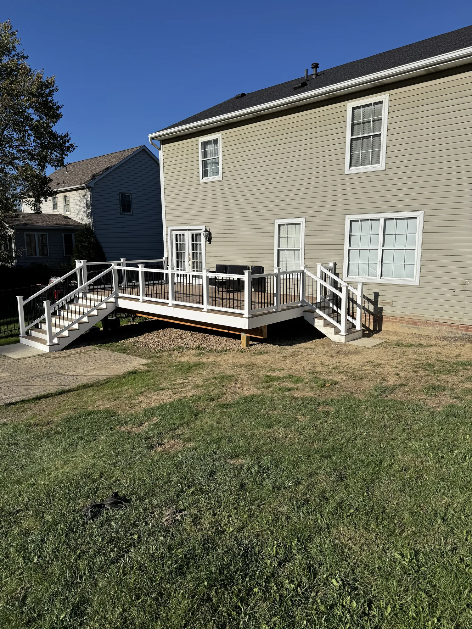 Composite deck with white railings and pergola on the back of a home in the North Hills of Pittsburgh