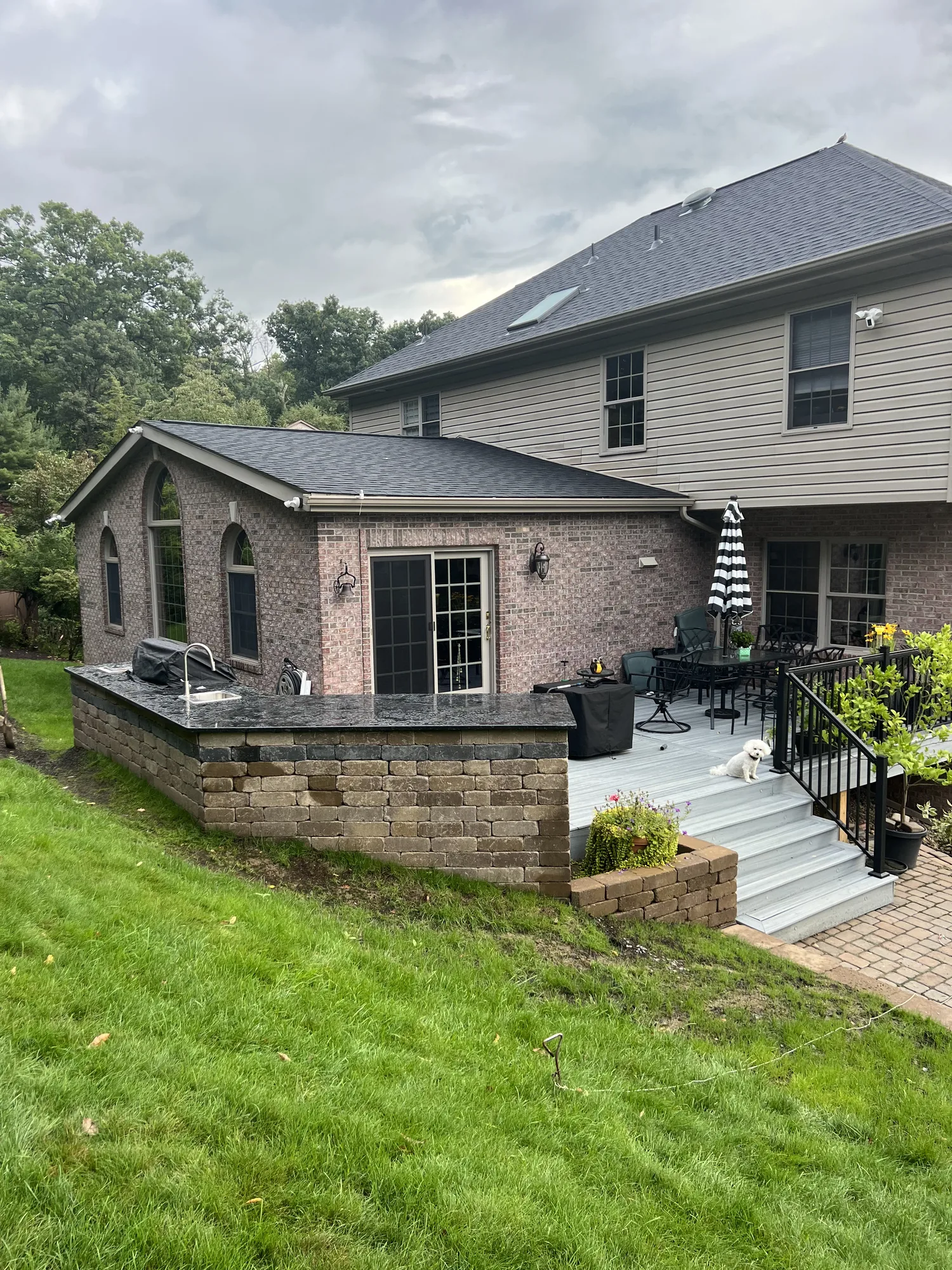 Segmental block retaining wall holding a slope behind a paver patio at a Pittsburgh area home