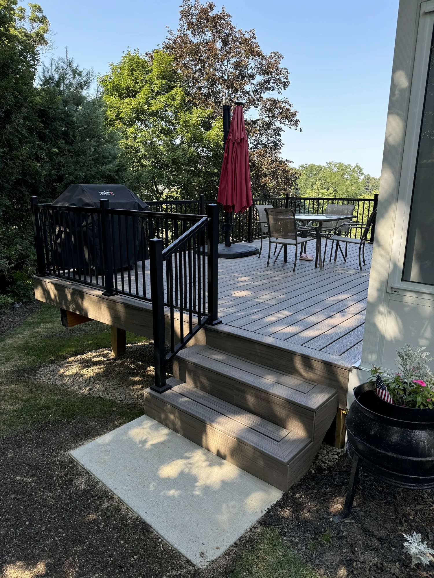 Composite deck with black railing and built in bench at a home near Pittsburgh