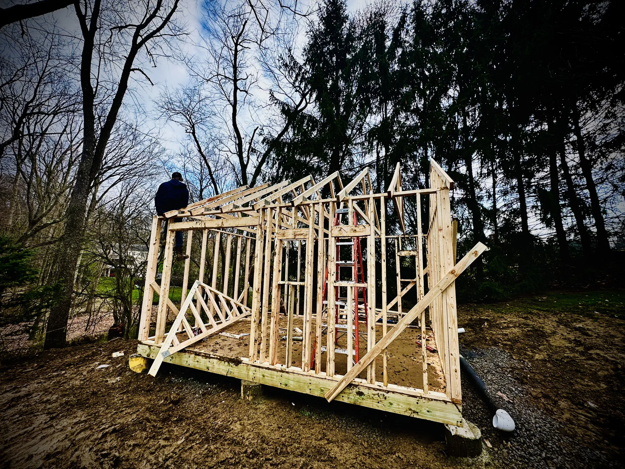 Framing crew building an outbuilding on a graded site in the North Hills of Pittsburgh
