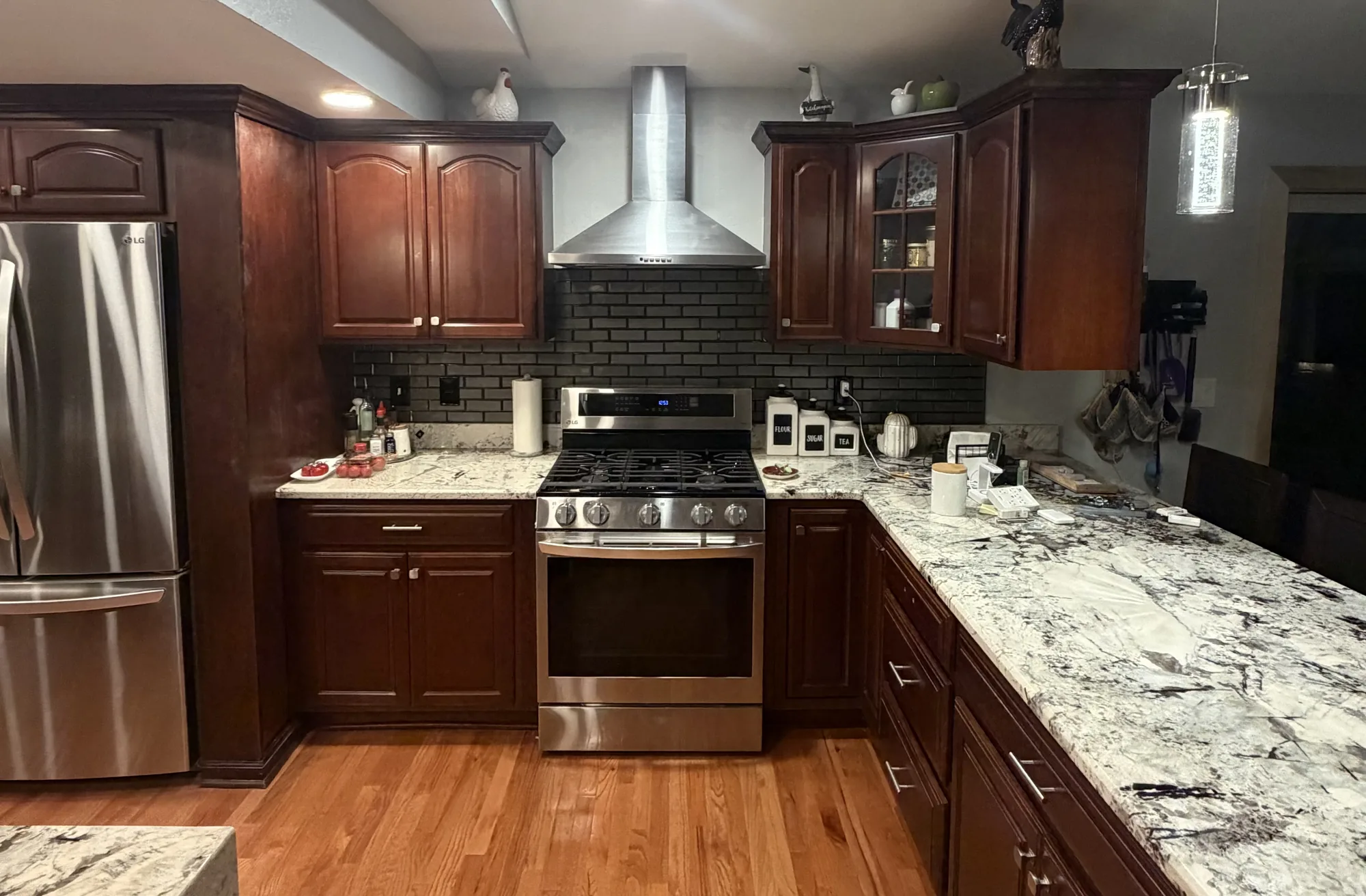 Remodeled kitchen with cherry cabinets, granite counters, and stainless appliances near Pittsburgh