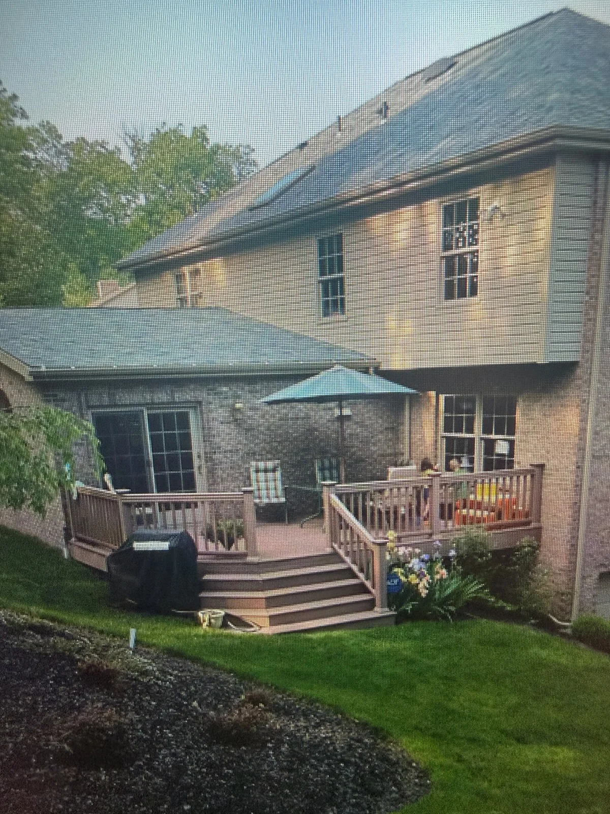 Before: Original wood deck and steps on the back of a brick home before the outdoor kitchen and composite deck were built